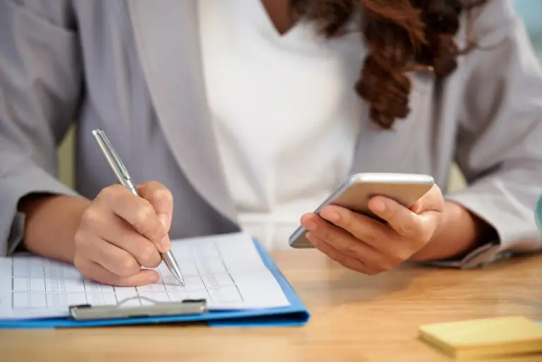 mid-section-anonymous-woman-working-with-business-document